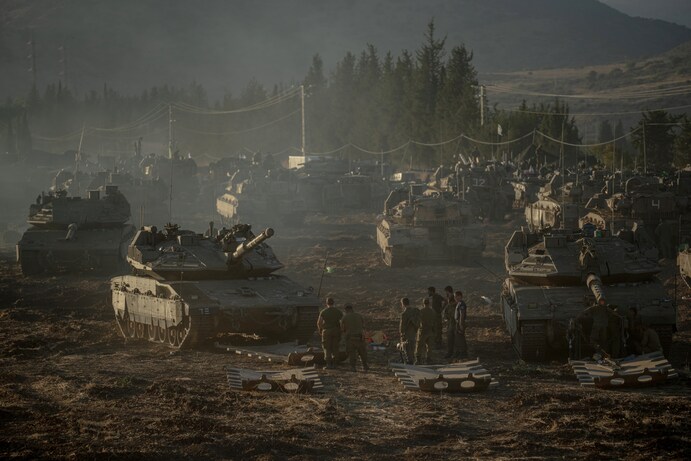Israeli-tanks-and-armored-personnel-carriers-gather-by-Israels-border-with-Lebanon-on-Monday.-Erik-MarmorGetty-Images